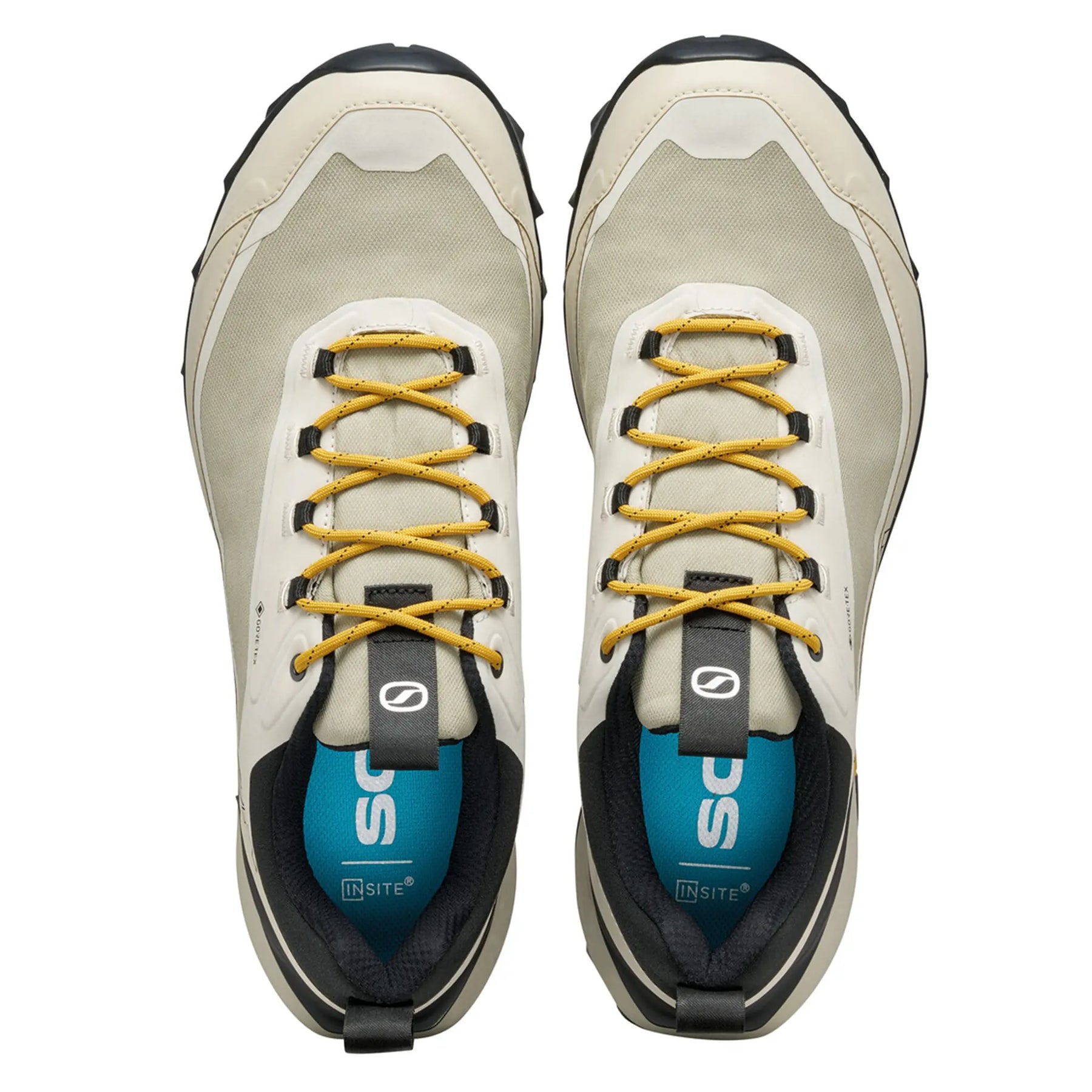 Pair of beige hiking shoes with yellow laces on a white background