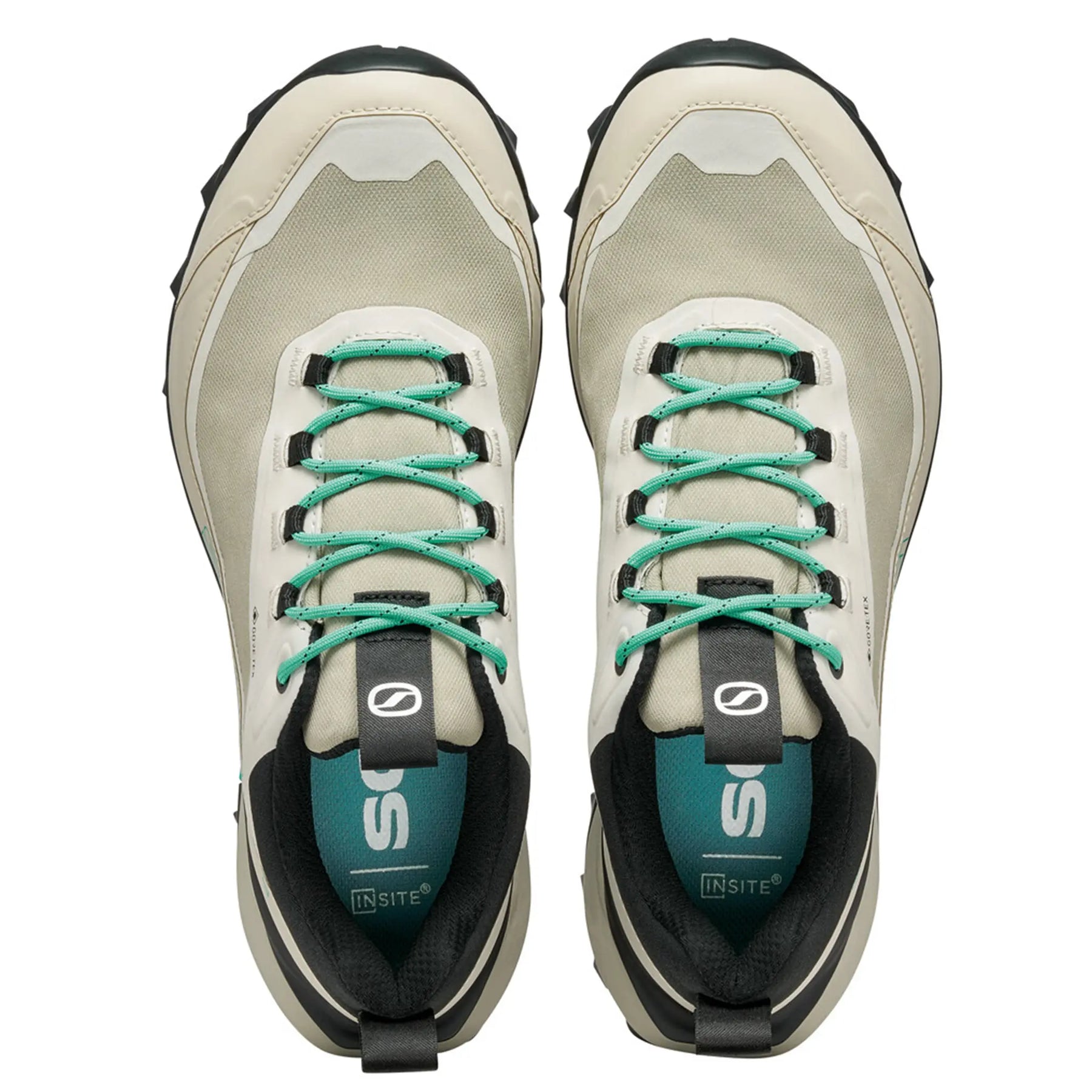 Pair of beige hiking shoes with green laces on a white background