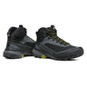 Pair of black hiking boots with green accents on a white background