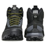 Black hiking boots with green laces on a white background