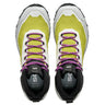 Pair of green and black athletic shoes with purple laces on a white background