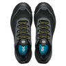 Black and gray athletic shoes with green laces on a white background