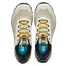 Pair of beige hiking shoes with yellow laces on a white background