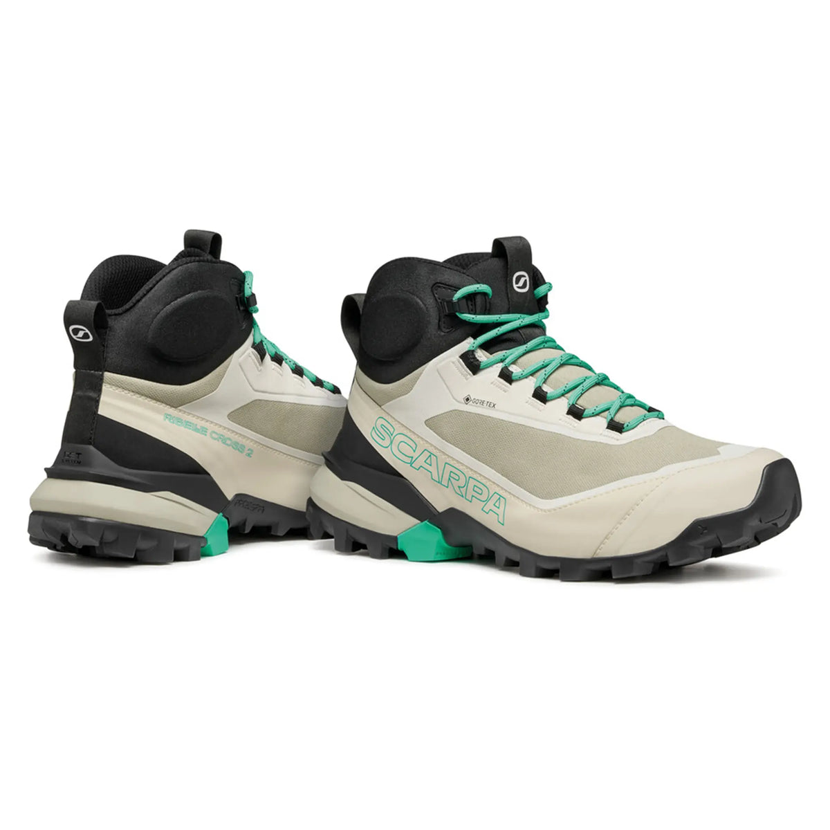 Pair of beige and black hiking boots with green accents on a white background